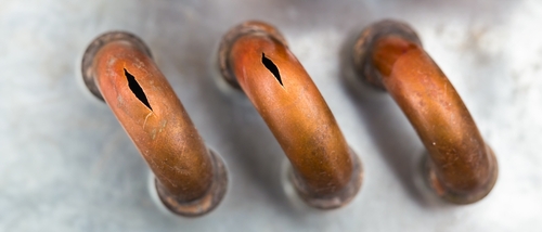 What is the safest way to thaw frozen pipes without causing damage